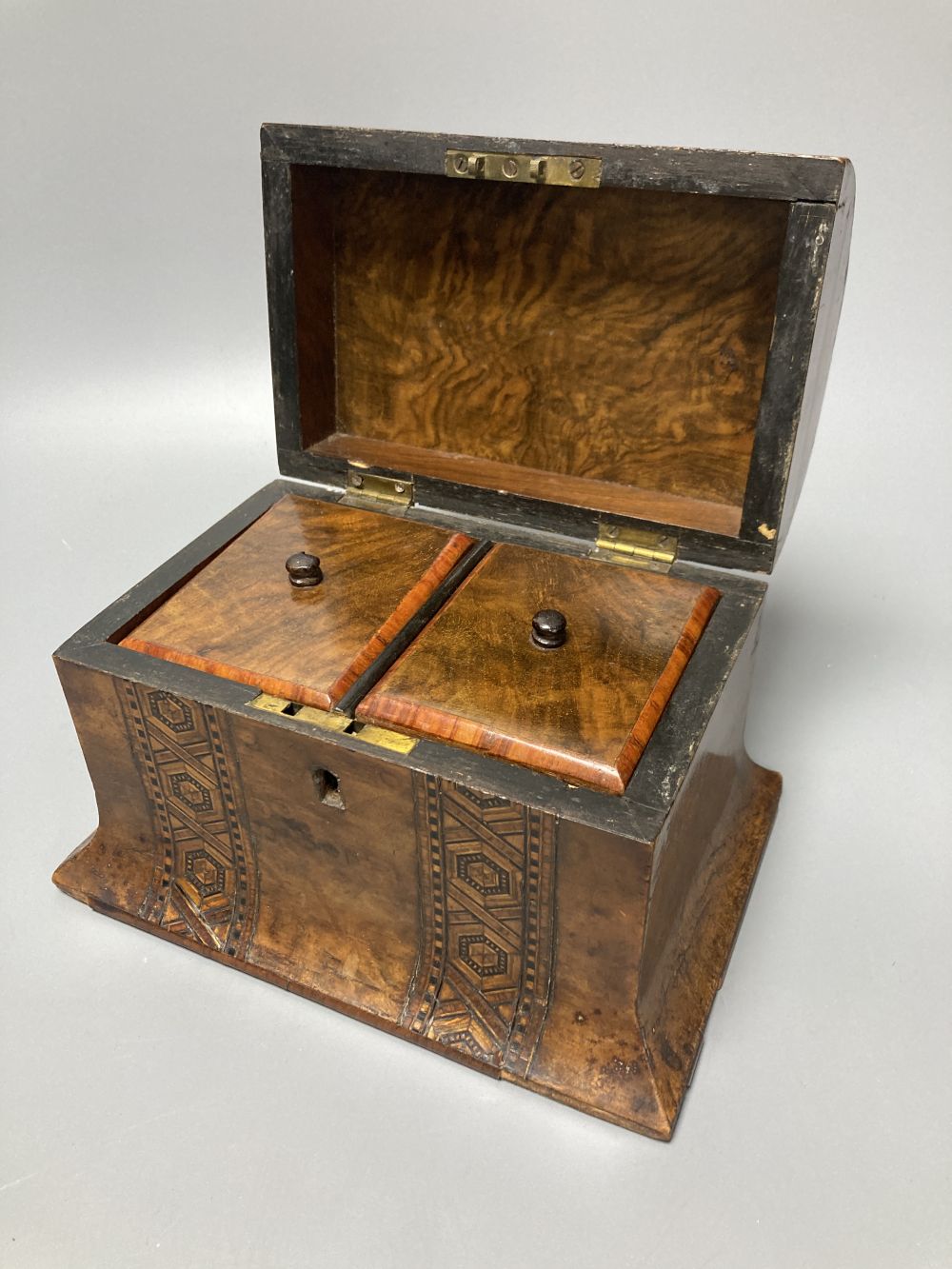 An Edwardian inlaid mahogany writing box, with hinged folding slope and fittings, 29cm, and a Victorian walnut and parquetry tea caddy,
